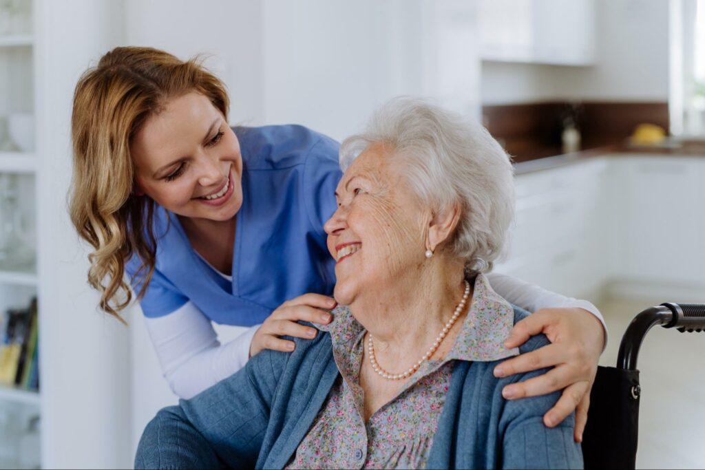 A caregiver checking in on an older adult woman.